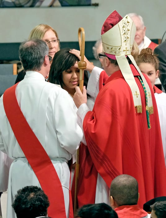 Confirmandi receiving annointing from Cardinal